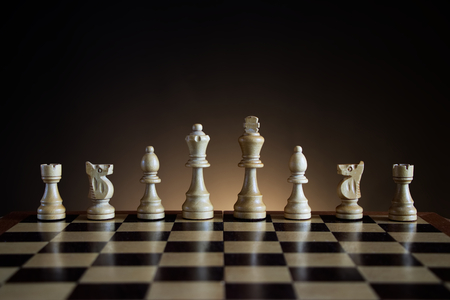 chessboard with white wooden figures, chess with a dark color gradient backgroundの写真素材