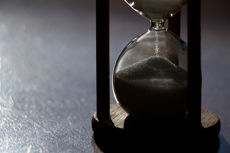 Hourglass time passing in contrast backlit. sandglass in sunlightの写真素材