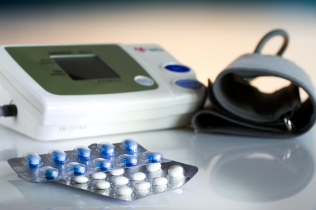 Medical pills against hypertension, equipment for measuring blood pressure in the background,の写真素材
