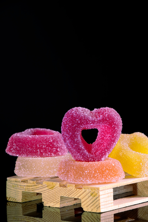 colored jelly candies on a black background, sugared sweets with large copy spaceの写真素材