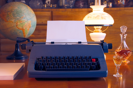 ready for writing a book, retro typewriter and lamp in antique wooden living room, vintage styleの写真素材