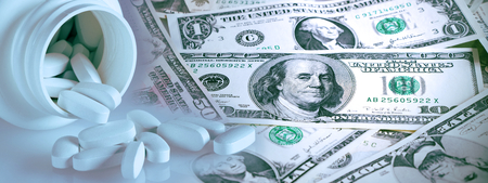 Concept of Health Care Costs. Drug Costs Money. Pills and US banknotes and banner. Dollars and tablets.の写真素材