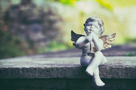 Porcelain angel as decoration in the cemetery. Angel statue as a symbol of romance.の写真素材
