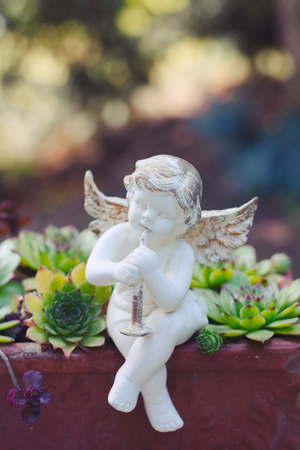 Porcelain angel as decoration in the garden. Angel statue as a symbol of romance. の写真素材