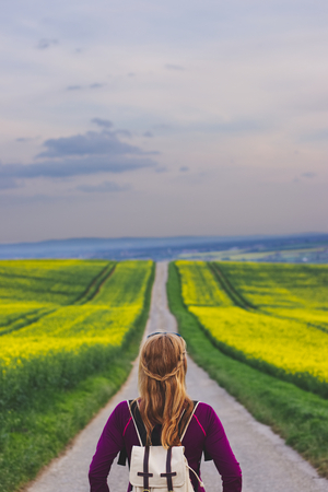 Woman travelling in countryside. Tourist standing on the road. Travel concept. Challenge of journeyの写真素材