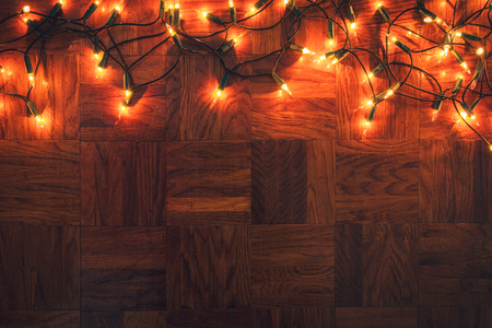 Christmas lights on wooden background. Merry christmas greeting card. Flat layの写真素材