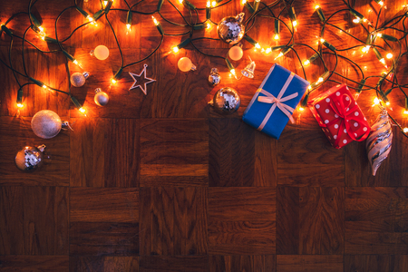 Christmas decoration with gift boxes, jingle bells and christmas lights. Merry christmas greeting cardの写真素材