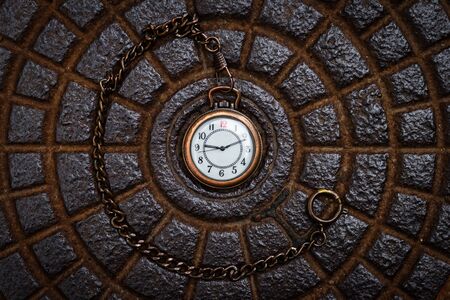 Pocket watch on metal texture background. Time concept. Retro clock face. Flat lay