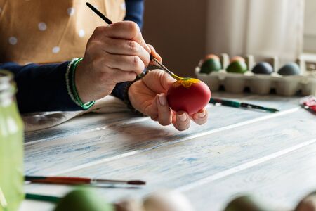 Woman painting easter eggs. Homemade decoration fot traditional religious holiday. Art and craft conceptの写真素材