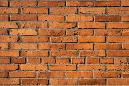 Vintage red brick wall background. Textured weathered surface. Part of building exteriorの写真素材