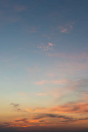 Colorful gradient sky background after sunset. Romantic sky with orange and blue colors. Clouds over horizonの写真素材