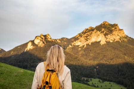Woman with backpack hiking in nature. Mountain peak Velky Rozsutec in national park Mala Fatra, Slovakia. Mountains trekkingの写真素材