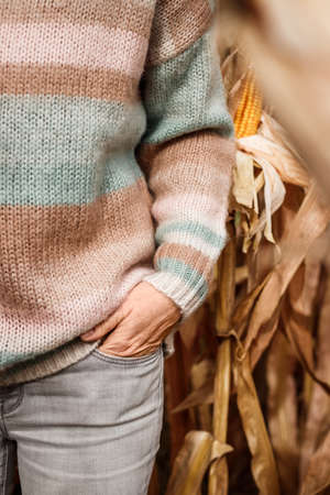 Woman wearing pastel colorful knitted sweater outdoors. Woolen clothing. Autumn fashion collectionの写真素材