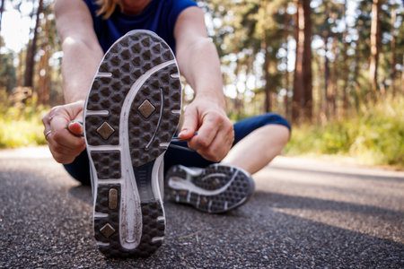 Woman tying shoelace of running shoe before jogging. Fitness and active lifestyleの写真素材