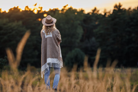 Woman relaxing in nature during sunset for good mental health and improve mindfulnessの写真素材