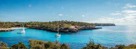 Cala Mondrago bay with beach and blue sea at Mallorca. Idyllic vacation and travel destination at the Balearic islands. Panoramic viewの写真素材