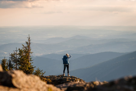 Hiker successfully climbed mountain summit. Woman hiking in mountainsの写真素材