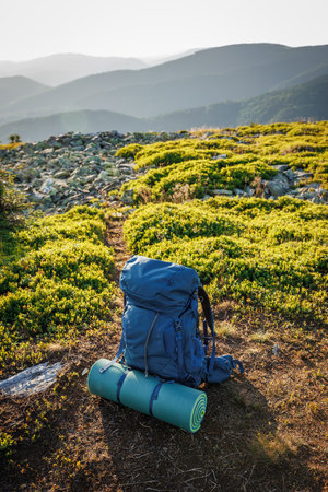 Backpack with sleeping pad. Hiking and trekking equipment in mountains. Travel and camping in natureの写真素材