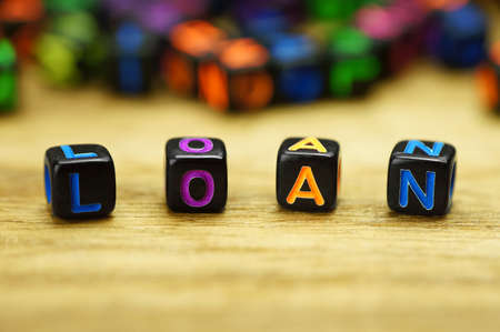 Words loan with dices on wooden tableの写真素材