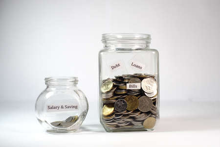 Small and large coin jar with label on it isolated on white backgroundの写真素材