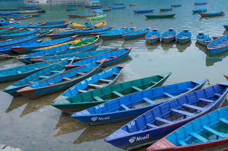 Colorful boat tethered to a dock as seen from aboveのeditorial素材