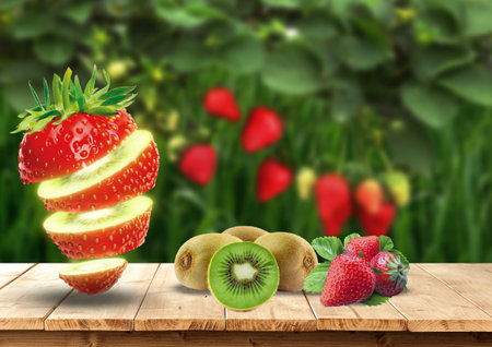Fruits on wooden table against strawberry and kiwi in gardenの写真素材