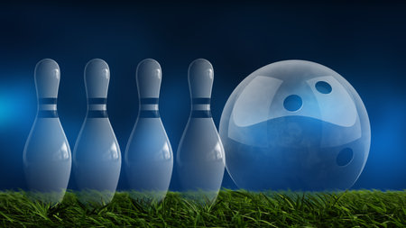 Glass bowling ball and skittles on green grass with blue backgroundの写真素材