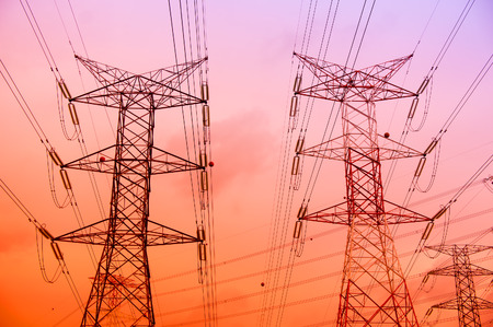 Electricity pylons and lines at sunset