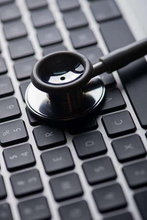 Shallow depth of field, keyboard with stethoscope low key photo concept