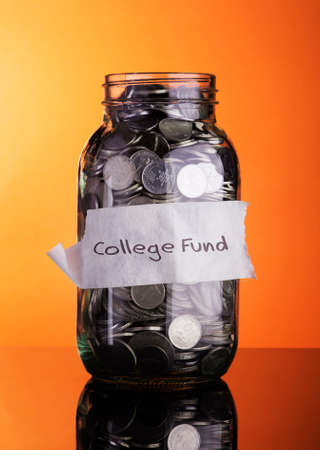 Coins in bottle with label College fund - financial conceptの写真素材