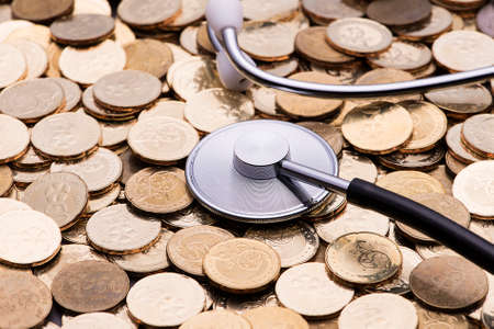 financial examination concept-stethoscope on currency coinの写真素材