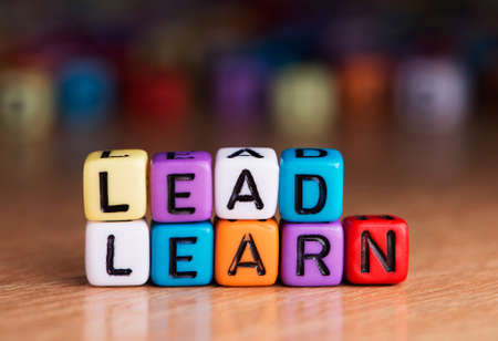 lead and learn words with dices on wooden tableの写真素材