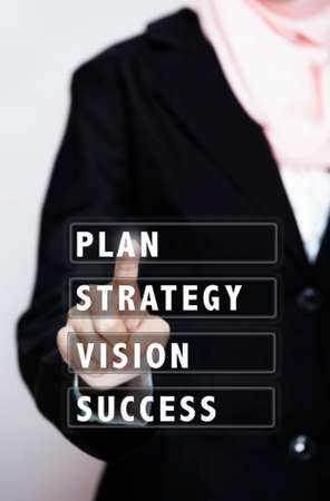 business women touch on virtual interface "PLAN,STRATEGY,VISION,SUCCESS"の写真素材