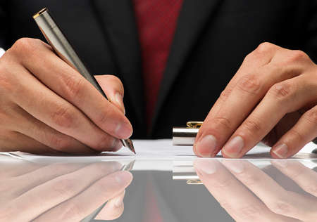 close up image hand writing a paper with reflection.