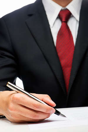 executive writes on paper