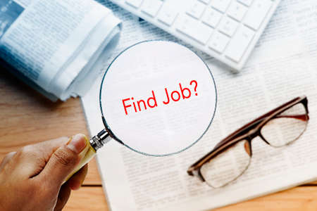 hand focusing word find job with magnifying glassの写真素材