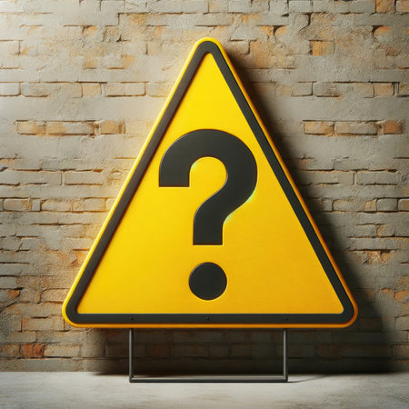 Question mark on a yellow warning sign on a brick wall. The sign draws attention to an unknown situation or puzzle, encouraging to look for answers.の素材