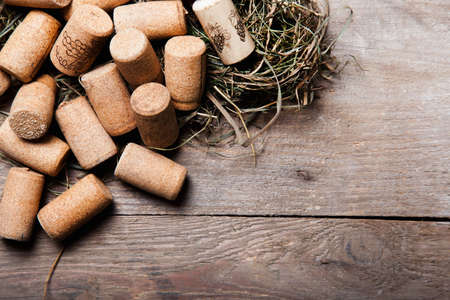 cork in upper corner with straw on woodの写真素材