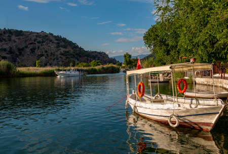 Dalyan, Mugla - Turkey. Boats view at slope of Lycians rock tombs in Dalyan Town.の写真素材