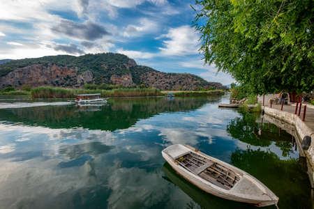 Dalyan, Mugla - Turkey. Boats view at slope of Lycians rock tombs in Dalyan Town.の写真素材