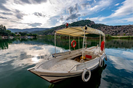 Dalyan, Mugla - Turkey. Boats view at slope of Lycians rock tombs in Dalyan Town.の写真素材
