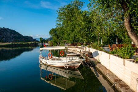 Dalyan, Mugla - Turkey. Boats view at slope of Lycians rock tombs in Dalyan Town.の写真素材