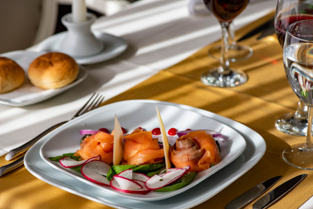 Salmon salad with radish, cucumber and radish on white plate