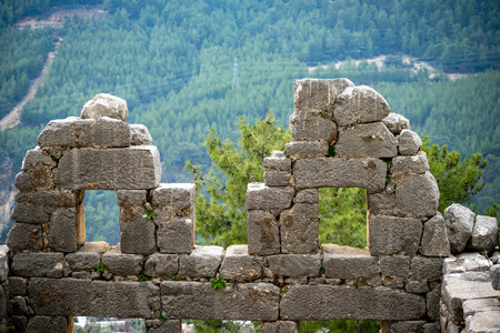Remains of gymnasium in acnient Lycian city Arycanda. Ancient city on mountain near Aykiricay village.Well preserved semi-circular theater of Arycanda, ancient Lycian city in Antalの写真素材
