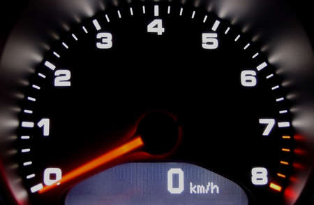 Sportscar dashboard closeup with backlit speedometer