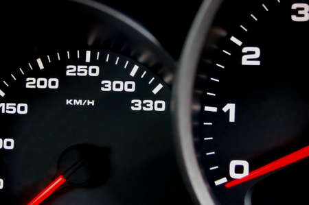 Sportscar dashboard closeup with backlit speedometer