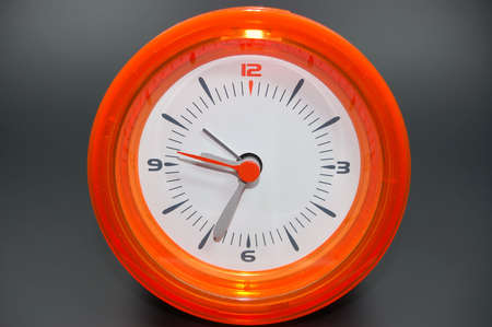 orange alarm clock on black backgroundの写真素材