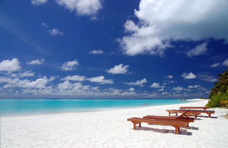 canvas chairs on tropical beachの写真素材