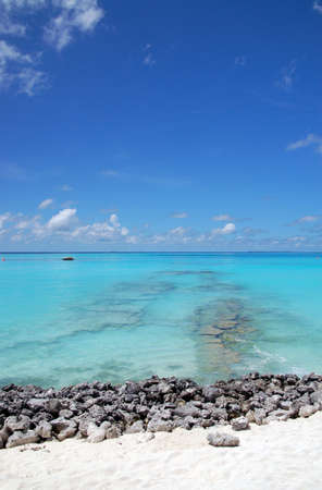 tropical maldivian beach with rocks and turquoise ocean の写真素材
