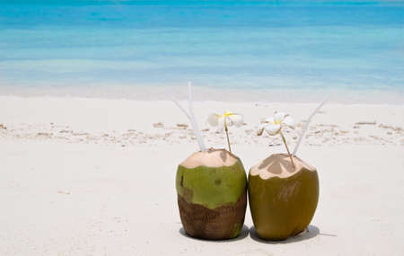 Tropical Coconut Cocktail in front of crystal blue oceanの写真素材